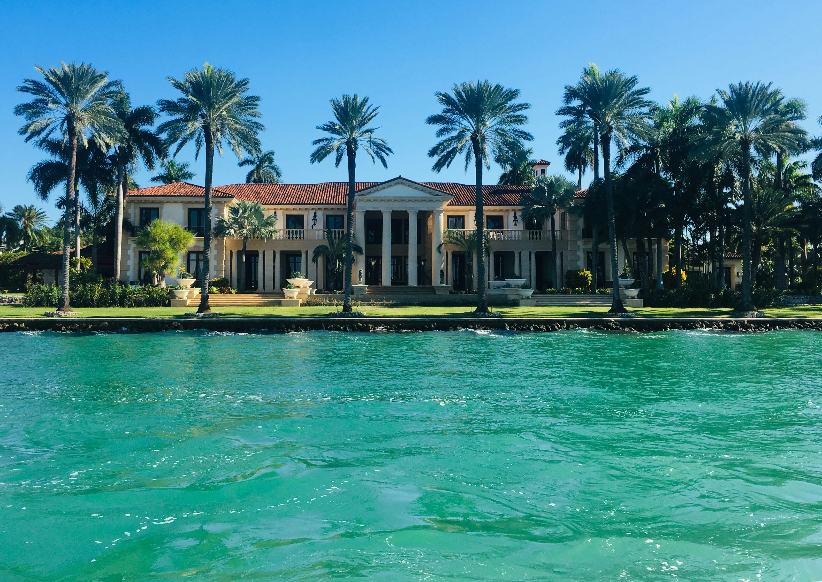 Miami waterfront estate with palm trees